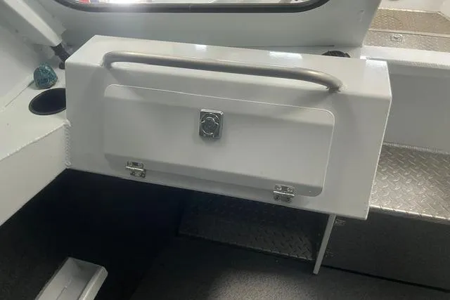 Slide: The Image of 2020 Hewescraft 240 Ocean Pro interior storage compartment with handle and latch. - 15