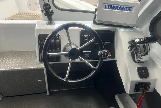 Slide: The Image of 2020 Hewescraft 240 Ocean Pro boat dashboard with steering wheel and Lowrance navigation system. - 11