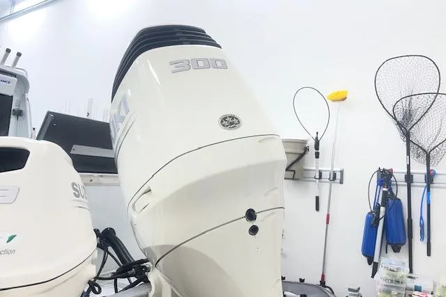 Slide: The Image of 2020 Hewescraft 240 Ocean Pro with Suzuki 300 outboard in a garage setting. - 4