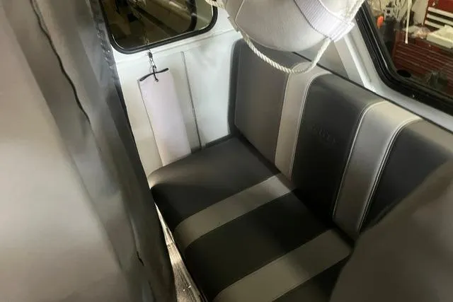Slide: The Image of Interior seating of 2020 Hewescraft 240 Ocean Pro boat, featuring gray and black upholstery. - 18