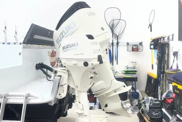 Slide: The Image of Suzuki outboard motor on 2020 Hewescraft 240 Ocean Pro boat in a garage setting. - 3