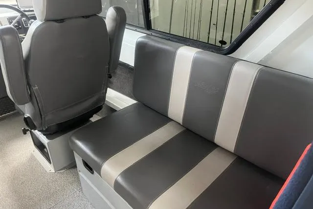 Slide: The Image of Interior seating of 2020 Hewescraft 240 Ocean Pro boat, featuring gray and beige upholstery. - 12