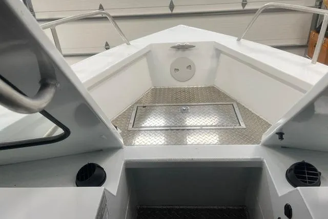 Slide: The Image of 2020 Hewescraft 240 Ocean Pro boat interior with diamond plate flooring and railing. - 16