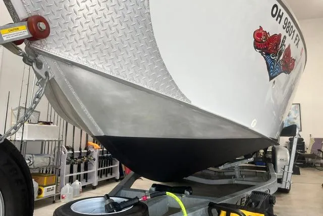 Slide: The Image of 2020 Hewescraft 240 Ocean Pro boat on trailer in garage setting. - 6