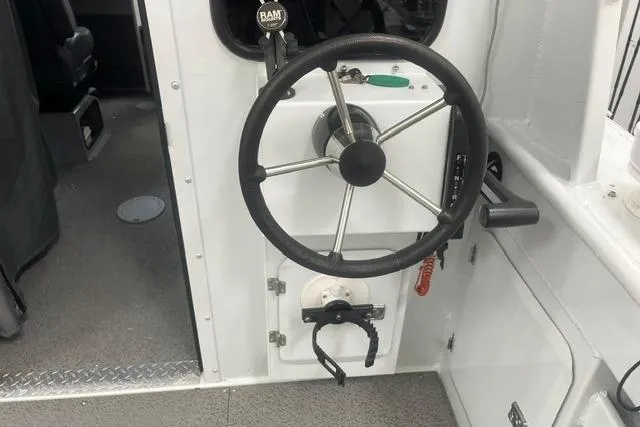 Slide: The Image of Steering wheel of a 2020 Hewescraft 240 Ocean Pro boat interior. - 20