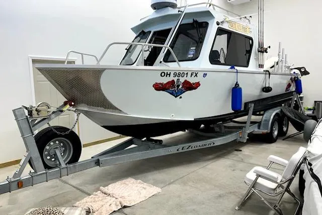 Slide: The Image of 2020 Hewescraft 240 Ocean Pro boat on trailer in garage setting. - 3