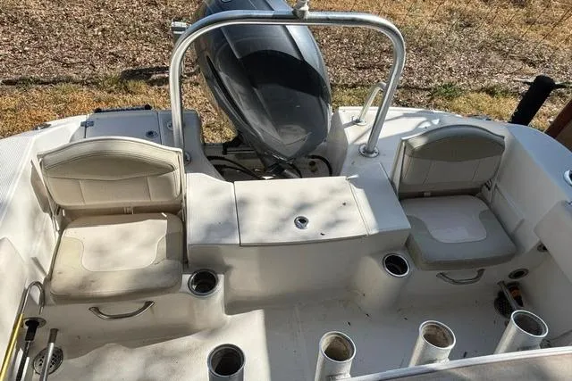 Slide: The Image of 2017 Robalo R200 Center Console boat interior with seating and rod holders. - 12