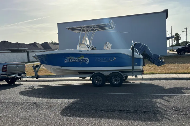 The Image of 2017 Robalo R200 Center Console boat on trailer, parked on street. - 0