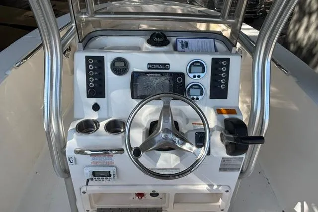 Slide: The Image of 2017 Robalo R200 Center Console boat dashboard with steering wheel and controls. - 11