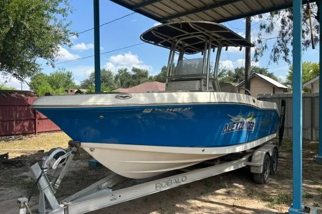 Slide: The Image of 2017 Robalo R200 Center Console boat on trailer under shelter. - 1