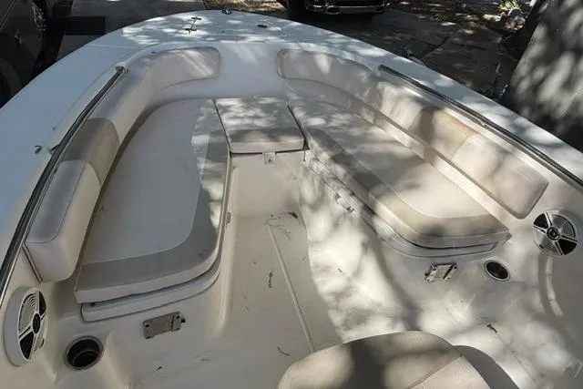 Slide: The Image of 2017 Robalo R200 Center Console boat interior with cushioned seating and storage compartments. - 7