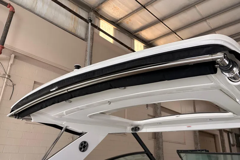 Slide: The Image of 2027 Sea Ray Sundancer 320 boat canopy detail in a warehouse setting. - 16