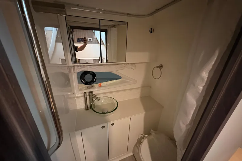 Slide: The Image of Bathroom interior of 2027 Sea Ray Sundancer 320 yacht, featuring modern fixtures and mirror. - 21