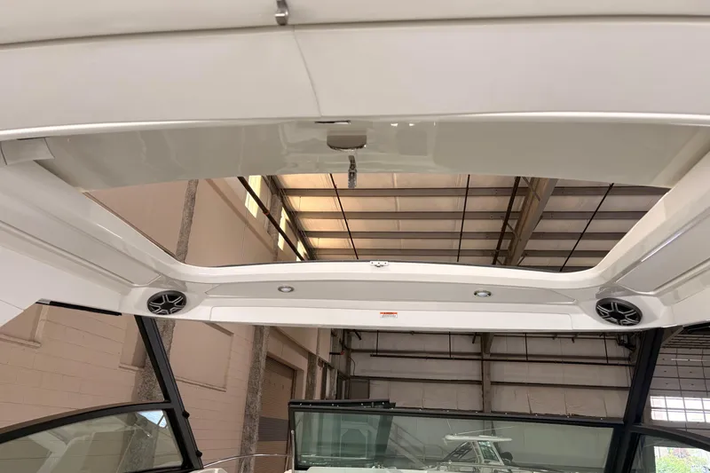 Slide: The Image of 2027 Sea Ray Sundancer 320 boat interior with open sunroof and speakers. - 15