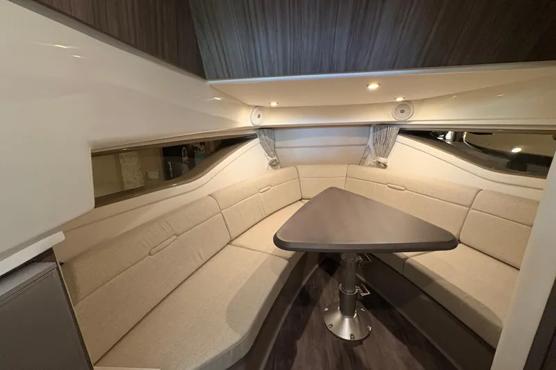 Slide: The Image of Luxurious interior of 2027 Sea Ray Sundancer 320 yacht with elegant seating and table. - 19