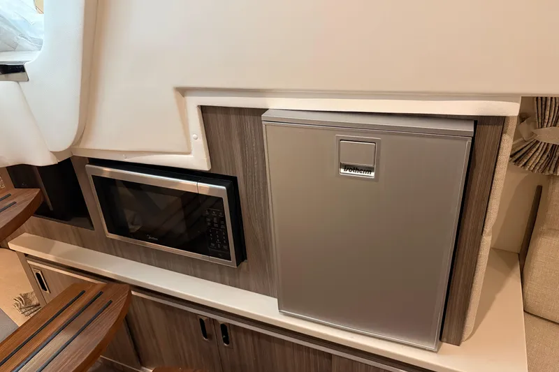 Slide: The Image of Interior of 2027 Sea Ray Sundancer 320 with microwave and compact fridge. - 20