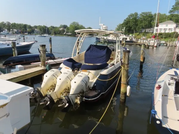 Slide: The Image of A 2016 Chris-Craft 36 Launch boat docked. It features two outboard engines. - 3