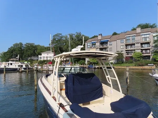 Slide: The Image of A 2016 Chris-Craft 36 Launch is docked in the water near a residential area. - 1