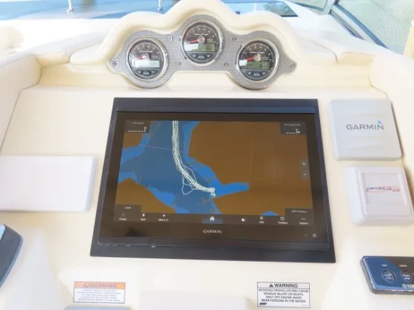 Slide: The Image of The image shows the dashboard of a Chris-Craft 36 Launch boat with a Garmin navigation system. - 16