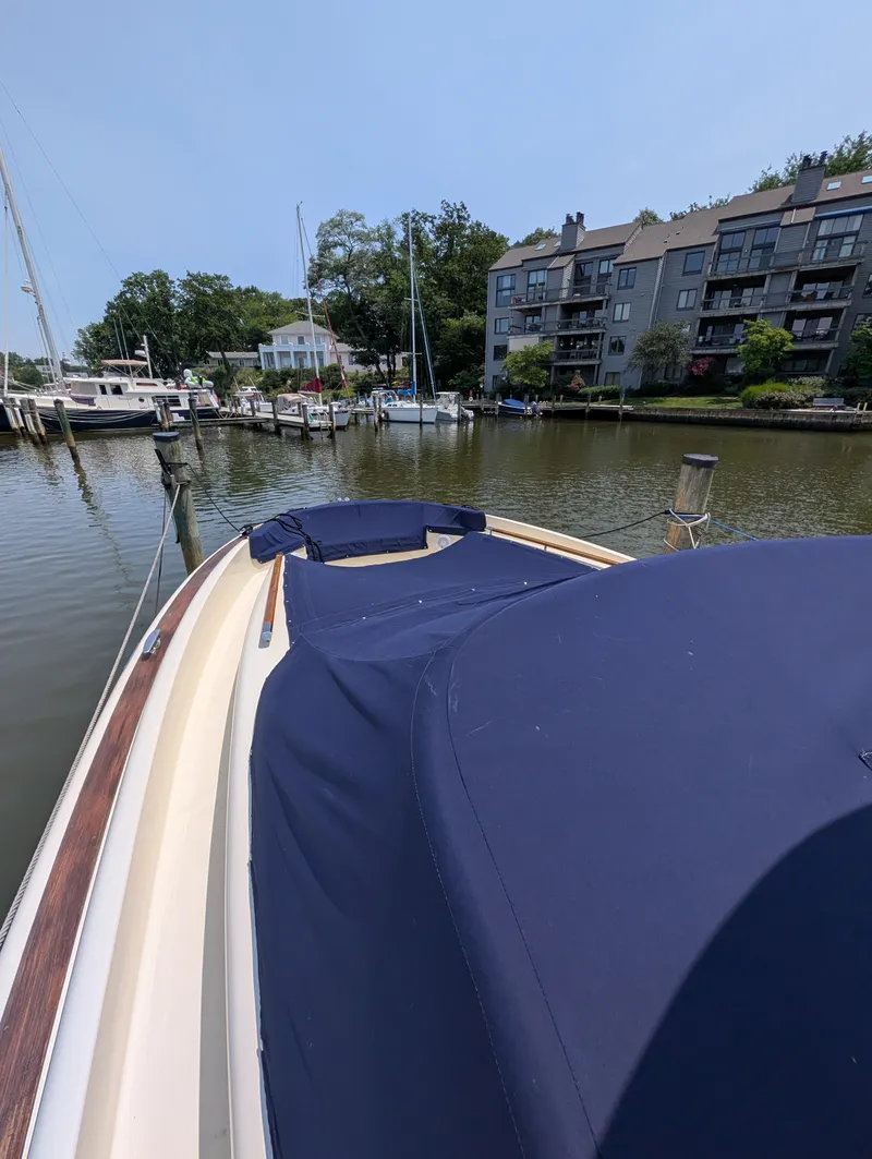 Slide: The Image of 2016 Chris-Craft 36 Launch in a calm harbor with residential buildings in the background. - 8