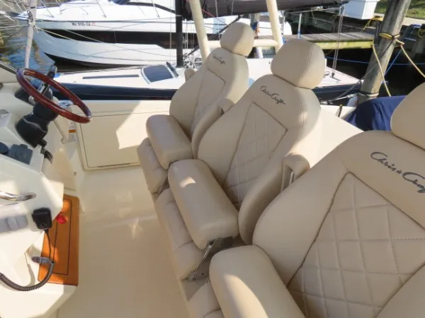 Slide: The Image of The image shows beige leather seats on a 2016 Chris-Craft 36 Launch boat. - 15