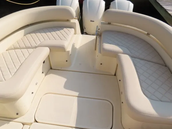 Slide: The Image of The image shows the cockpit of a 2016 Chris-Craft 36 Launch with cream-colored upholstery. - 19