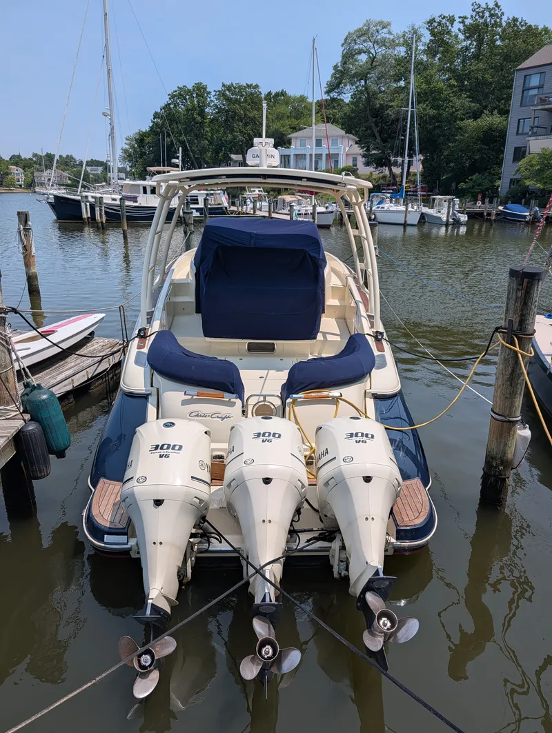 Slide: The Image of A 2016 Chris-Craft 36 Launch docked. It features three outboard engines and spacious seating. - 11