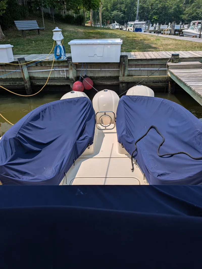 Slide: The Image of A 2016 Chris-Craft 36 Launch docked. The seats are covered with blue protective covers. - 9