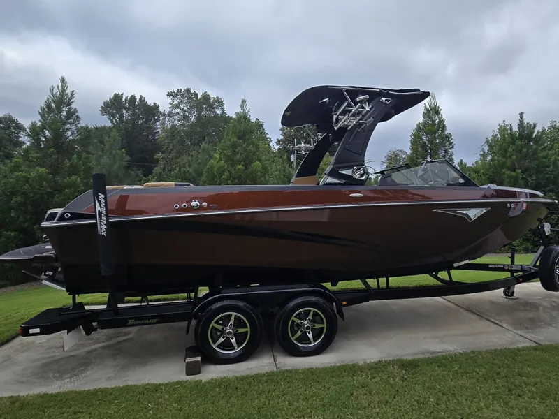 Slide: The Image of 2022 Tigé Z3 on a trailer, brown body, black roof, parked on a driveway. - 29