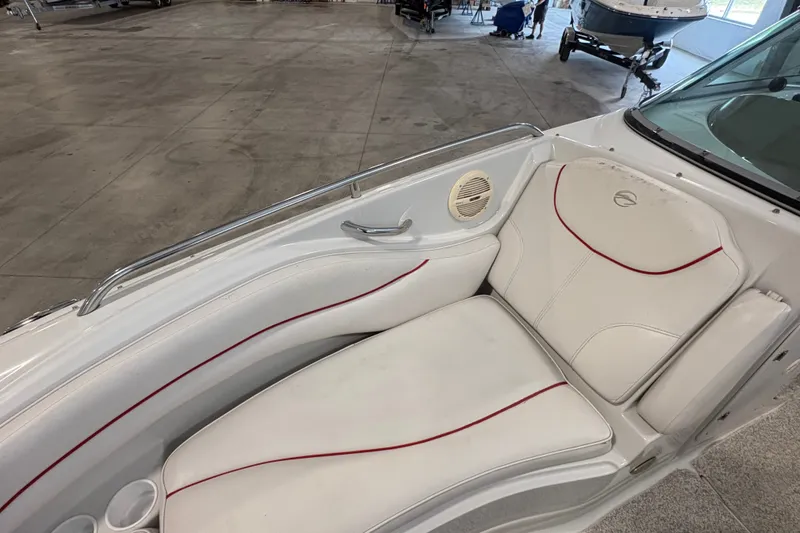Slide: The Image of 2005 Crownline 220 EX boat interior with white seating and red accents. - 19