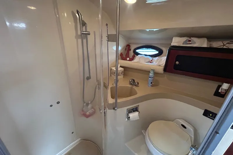 Slide: The Image of 2001 Wellcraft 3700 Martinique bathroom with shower, sink, and toilet. - 28