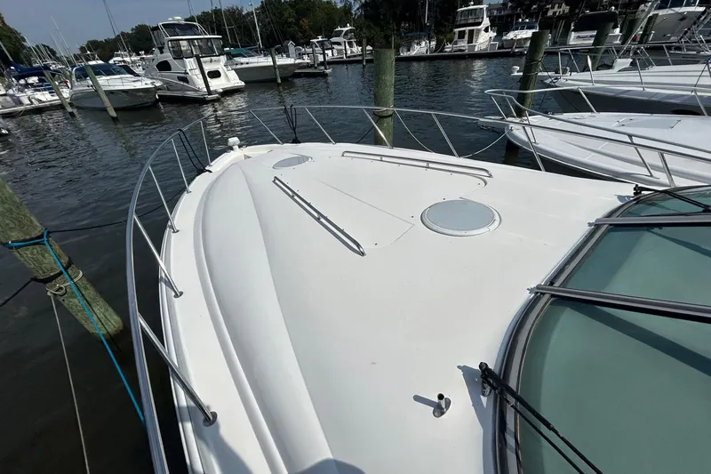 Slide: The Image of 2001 Wellcraft 3700 Martinique yacht docked in a marina, surrounded by other boats. - 6