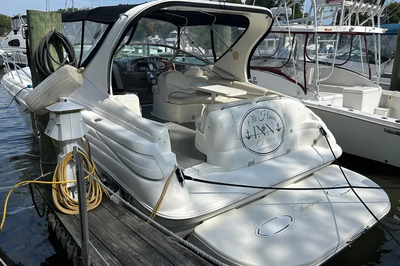 Slide: The Image of 2001 Wellcraft 3700 Martinique yacht docked at marina, featuring spacious cockpit and elegant design. - 3
