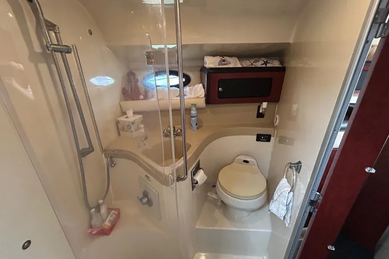 Slide: The Image of 2001 Wellcraft 3700 Martinique bathroom with shower, toilet, and storage cabinet. - 27