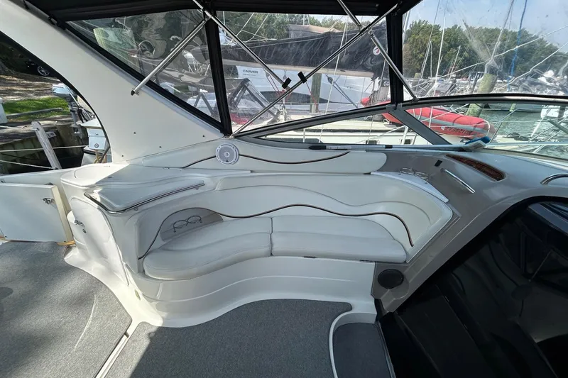 Slide: The Image of 2001 Wellcraft 3700 Martinique boat interior with white seating and large windows. - 13