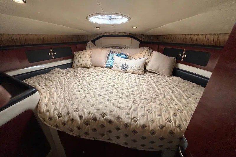 Slide: The Image of Luxurious cabin interior of 2001 Wellcraft 3700 Martinique with plush bedding and pillows. - 24
