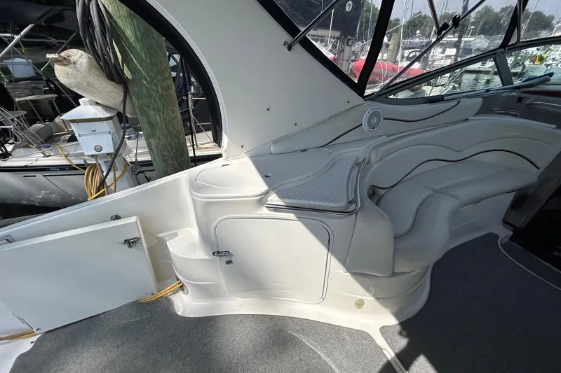 Slide: The Image of 2001 Wellcraft 3700 Martinique boat interior with white seating and dockside view. - 12