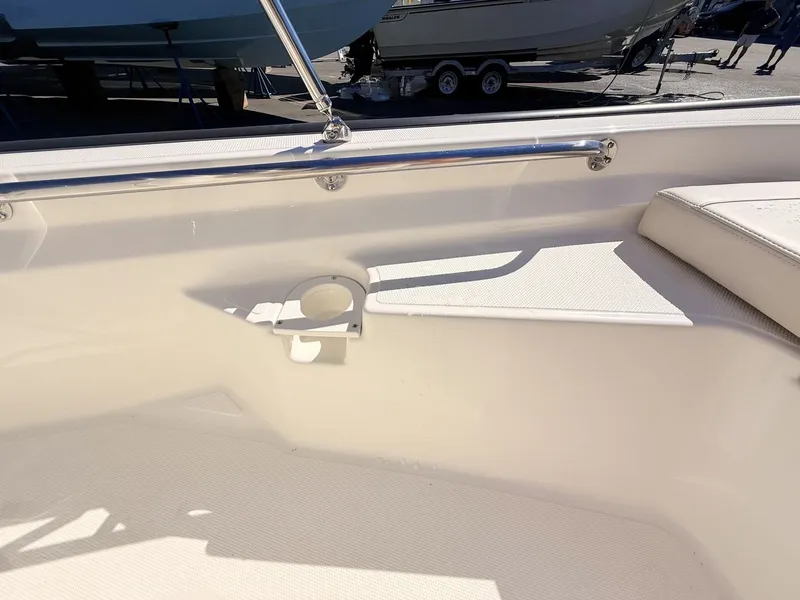 Slide: The Image of The image shows the interior of a Boston Whaler 150 Montauk with a cup holder. - 37