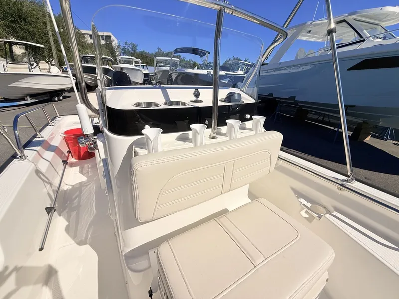 Slide: The Image of The image shows the cockpit of a Boston Whaler 150 Montauk with white seats and a helm console. - 31