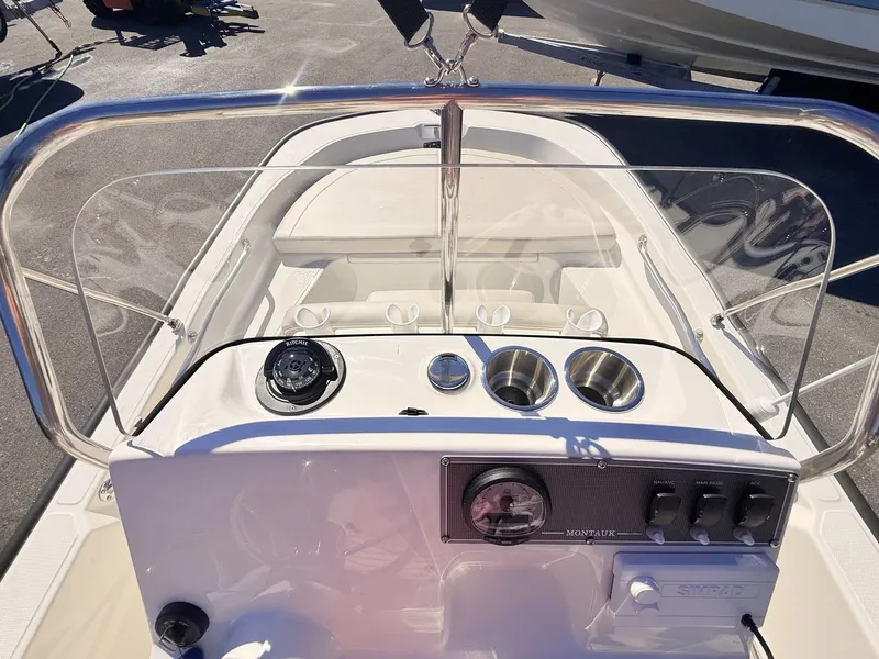 Slide: The Image of The image shows the cockpit of a Boston Whaler 150 Montauk with controls and instruments. - 23