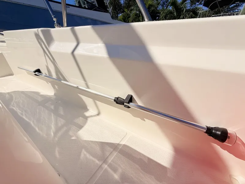 Slide: The Image of A boat with a clean, white interior surface and a mounted rod on the side. - 22