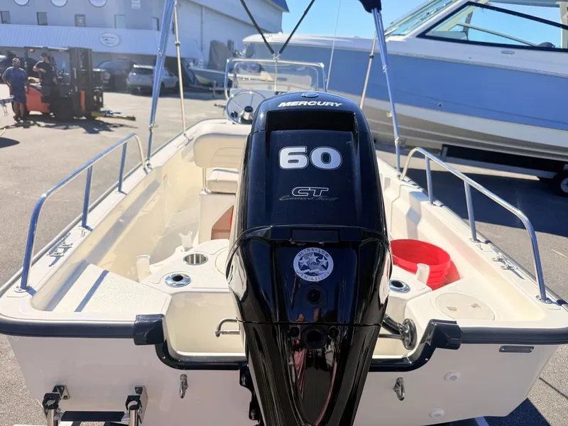 Slide: The Image of The image shows a 2027 Boston Whaler 150 Montauk boat with a 60 HP Mercury engine. - 15