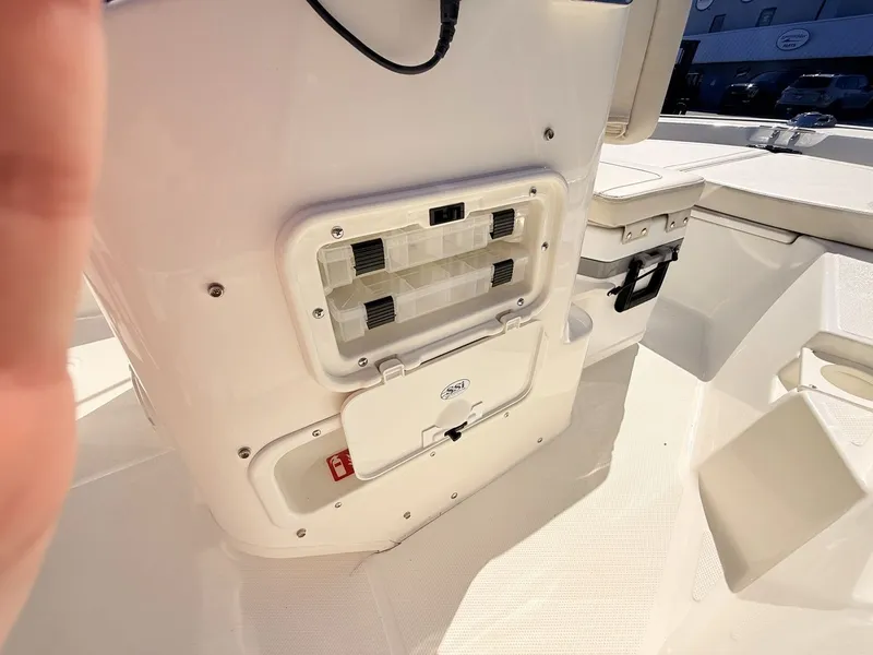 Slide: The Image of Close-up of the helm area on a 2027 Boston Whaler 150 Montauk, featuring storage compartments. - 28