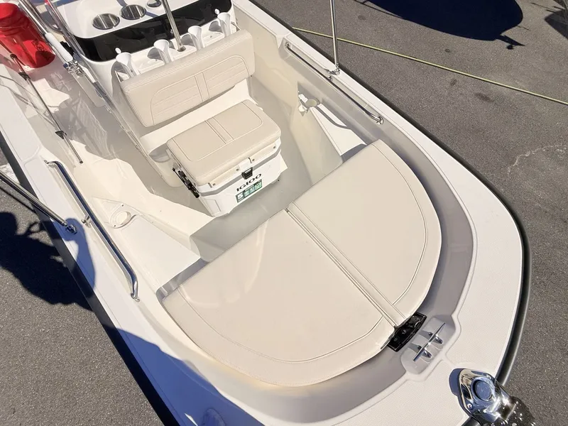 Slide: The Image of The image shows the cockpit of a Boston Whaler 150 Montauk with beige seating and storage. - 29