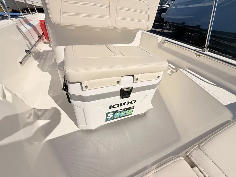 Slide: The Image of A white Igloo cooler on a boat with beige seating. - 32