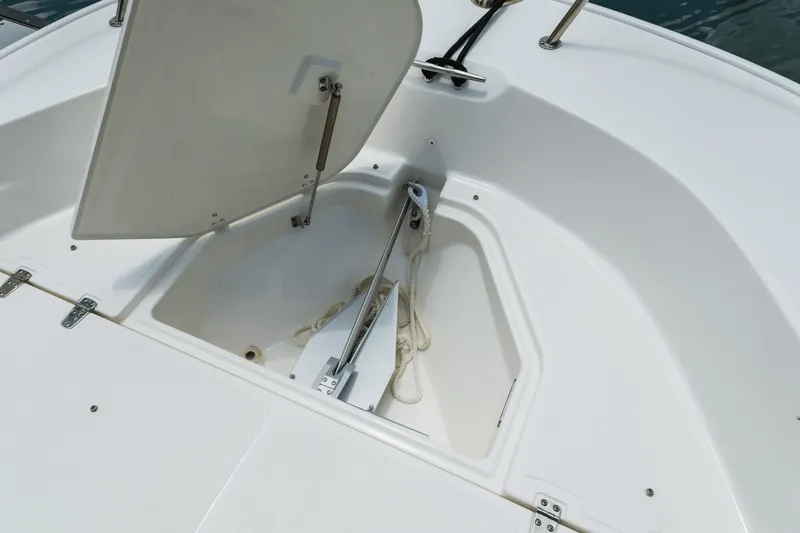 Slide: The Image of An open storage compartment on a boat with an anchor and rope inside. - 29