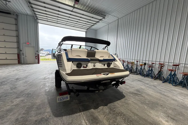 Slide: The Image of 2022 Scarab 195 ID boat in a spacious indoor storage facility. - 2