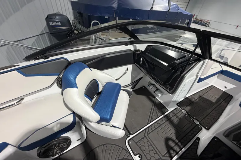 Slide: The Image of Interior of 2022 Scarab 195 ID boat with blue and white seating and dashboard. - 11