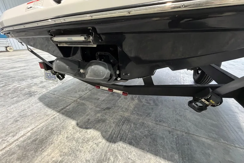 Slide: The Image of Rear view of a 2022 Scarab 195 ID boat on a trailer in a garage. - 1