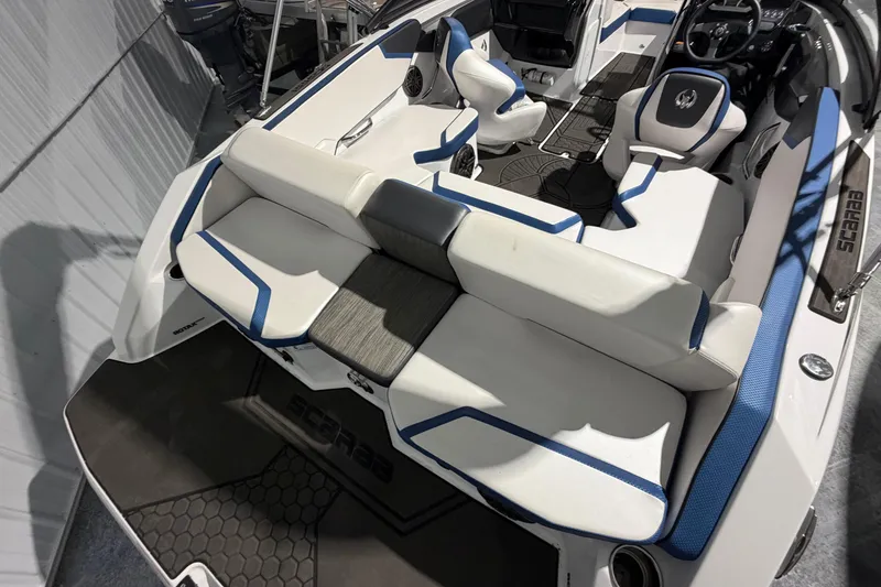 Slide: The Image of 2022 Scarab 195 ID boat interior with white and blue seating, modern design. - 13
